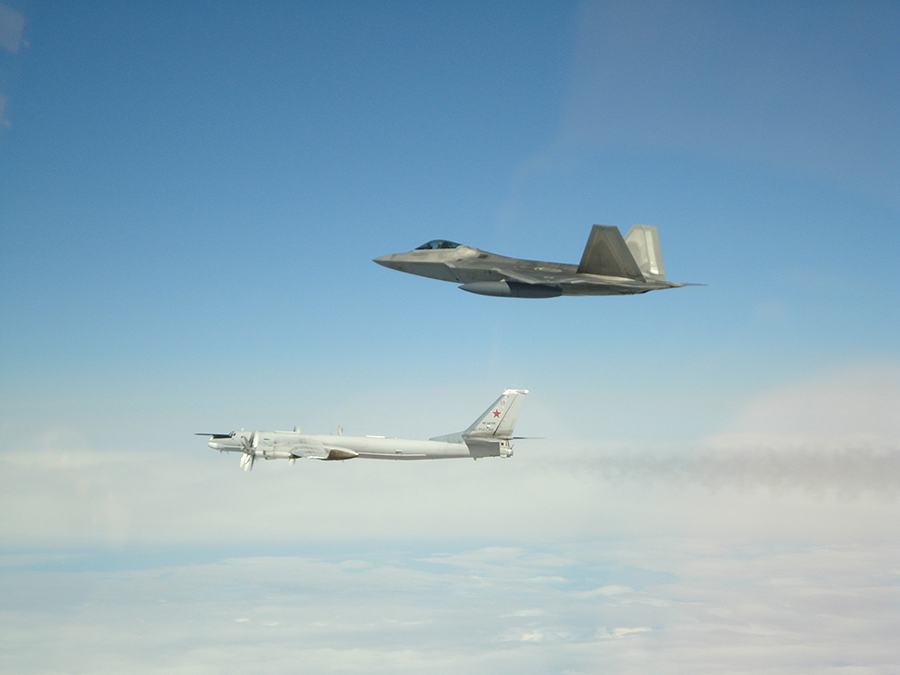A U.S. F-22 fighter shadows a Russian Tu-95 bomber on May 20 in international airspace near Alaska. Aircraft and missile detection systems rely heavily on electronic communications, making them potential targets for cyberwarfare. (Photo: NORAD)