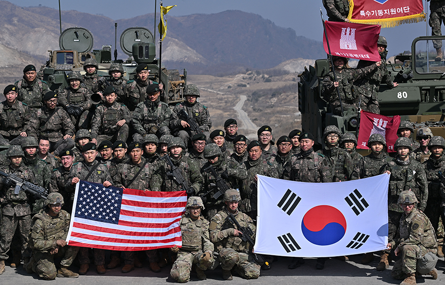 South Korean and U.S. soldiers pose for photos in March after their joint live fire exercise at a military training field in Pocheon, part of an annual event. (Photo by Jung Yeon-Je/POOL/AFP via Getty Images)