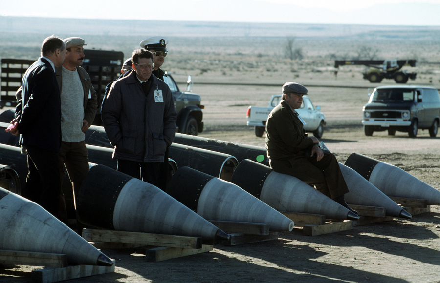Soviet inspectors and their American escorts stand among U.S. Pershing II missiles destroyed in accordance with the Intermediate-Range Nuclear Forces Treaty in a photo taken January 14, 1989. (Photo credit: MSGT Jose Lopez Jr./U.S. Defense Department)