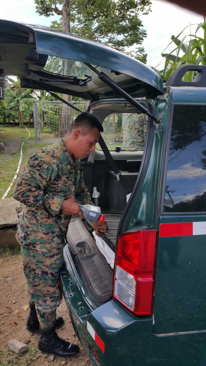A Panamanian border police officer uses an isotope identifier to detect radiation during a mock vehicle inspection. Credit: U.S. Department of State
