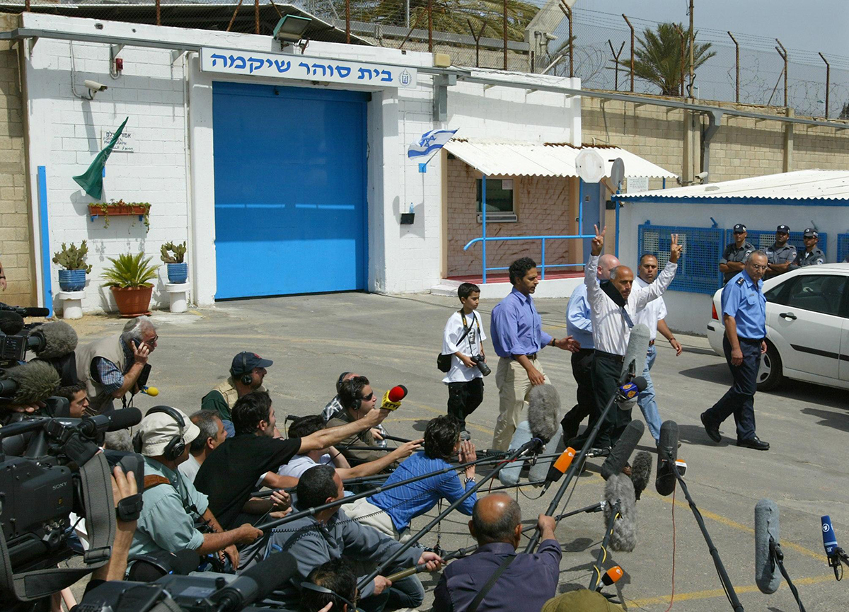 Former Israeli nuclear technician Mordechai Vanunu flashes the V-for-victory sign as he leaves prison April 21, 2004, after an 18-year sentence for revealing details of Israel’s secret nuclear-weapons program. In 2005, he told Israel’s Channel 2 television that he had acted after becoming alarmed by the danger posed by Israel’s nuclear weapons program. Under a policy of “strategic ambiguity,” Israel neither confirms nor denies having the region’s only nuclear weapons. (Photo credit: Pedro Ugarte/AFP/Getty Images)
