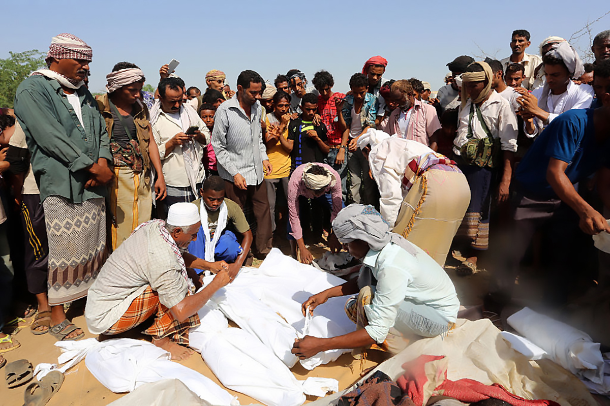 Yemenis wrap in shrouds the bodies of members of the same family during their funeral on October 8, 2016, a day after they were killed in a reported airstrike by Saudi-led coalition airplanes that hit their house in Bajil. (Photo credit: Stringer/AFP/Getty Images)