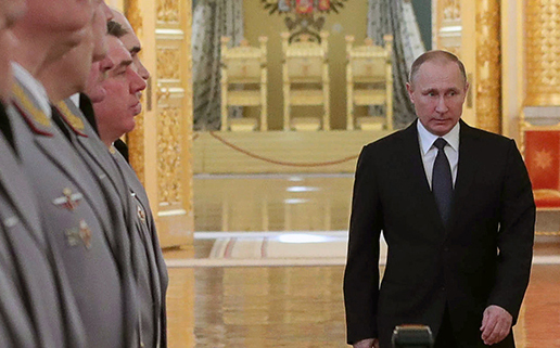 Russian President Vladimir Putin enters a hall in the Kremlin March 23 to meet with senior military officers promoted to higher positions. (Photo credit: Mikhail Klimentyev/AFP/Getty Images)