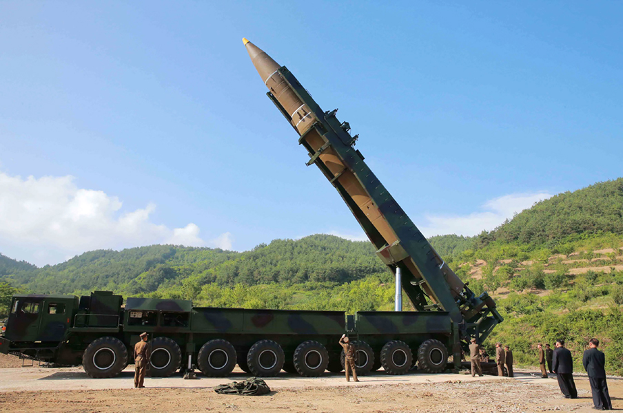 This photograph, released on July 4 by North Korea’s official Korean Central News Agency, shows North Korean leader Kim Jong Un (second on R) inspecting a Hwasong-14 intercontinental ballistic missile. (Photo credit: STR/AFP/Getty Images)