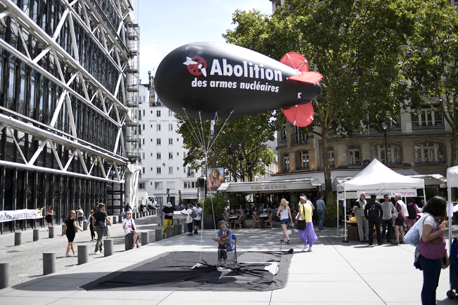 A balloon shaped like a nuclear bomb floats outside the Centre Georges Pompidou in Paris on August 7, as part of an effort to press France to sign the new UN treaty to prohibit nuclear weapons. France and other nuclear-weapons states, including the United States and Russia, did not participate in the negotiations and oppose the treaty. (Photo credit: Stephane De Sakutin/ Getty Images)
