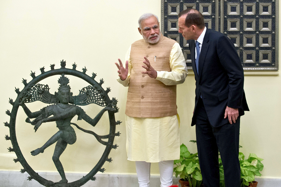 Indian Prime Minister Narendra Modi (L) gestures while talking with then-Australian Prime Minister Tony Abbott before a meeting in New Delhi on September 5, 2014 in which they concluded a civil nuclear cooperation deal. (Photo credit: Prakash Singh/AFP/Getty Images)