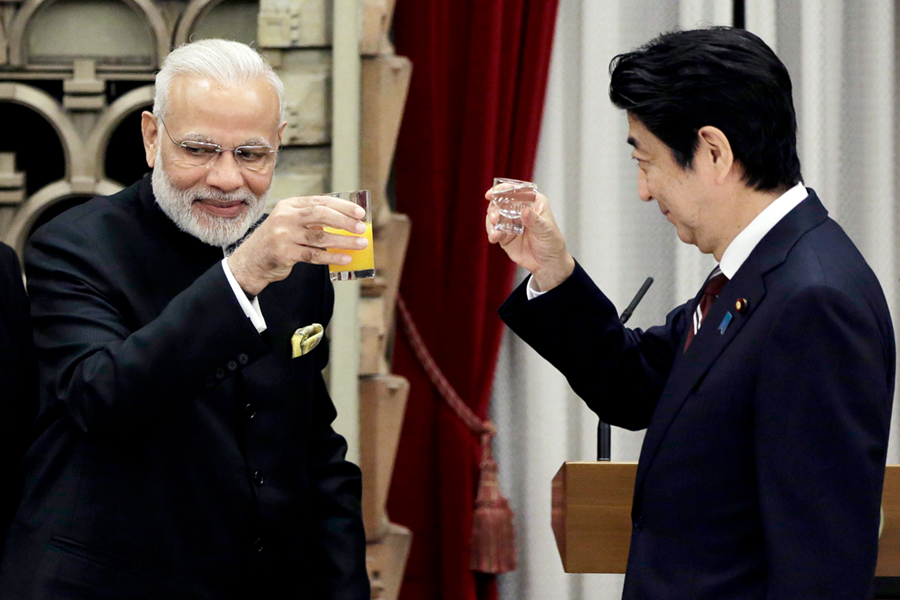Indian Prime Minister Narendra Modi (L) and his Japanese counterpart, Shinzo Abe, make a toast during a banquet at Abe’s official residence in Tokyo on November 11, 2016. (Photo credit: Kiyoshi Ota/AFP/Getty Images)