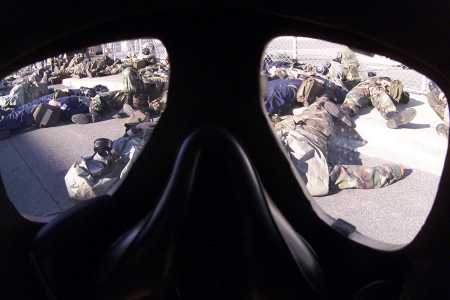 Marines participate in a simulated chemical weapons attack lie along a street during a mass casualty drill December 20, 2001. The major nuclear-weapon powers, other than China, have carved out potential exemptions to their negative security assurances in the case of an adversary using chemical or biological weapons. (Photo credit: Kurt Fredrickson/US Marines/Getty Images)