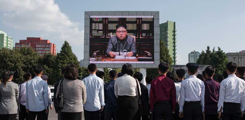 North Koreans in the capital, Pyongyang, on Sept. 22 (local time) watch a report on leader Kim Jong Un’s statement denouncing U.S. President Donald Trump as a “rogue and a gangster” who will “pay dearly” for his threats against their country. (Photo credit: Ed Jones/AFP/Getty Images)