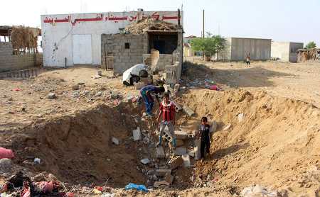 Yemeni children gather at a bomb crater from a reported air strike October 7 by the Saudi-led coalition that allegedly hit a health center in the northern province of Hajjah. (Photo credit: STR/AFP/Getty Images)