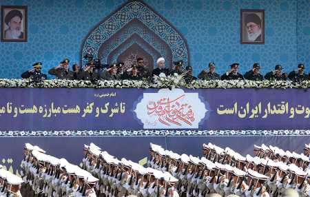 Iranian soldiers march Sept. 22 past President Hassan Rouhani during the annual military parade in Tehran marking the anniversary of the outbreak of its 1980-1988 war with Iraq. Rouhani vowed that Iran will boost its ballistic missile capabilities despite criticism from the United States.  (Photo credit: STR/AFP/Getty Images)