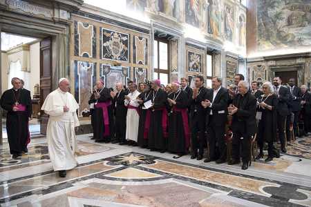 Pope Francis is greeted by participants at a conference on nuclear disarmament on November 10 at the Vatican.   (Photo credit: L'Osservatore Romano/Vatican)