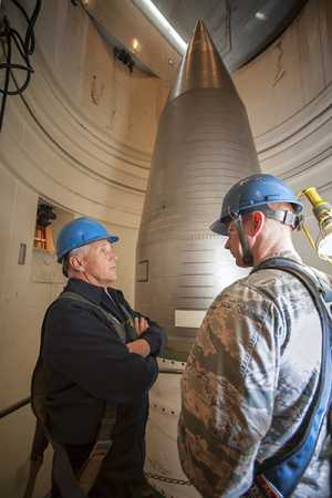 Vice President Mike Pence speaks with Air Force Captain Kevin O'Neill, 91st Missile Maintenance Squadron maintenance operations officer, beside a Minuteman III intercontinental ballistic missile near Lansford, N.D., on October 27.  (Photo credit: J.T. Armstrong/ U.S. Air Force)