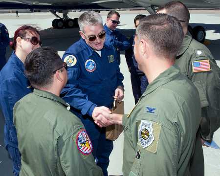 Russian Colonel Aleksey Gridnev, Russian Federation team chief, receives a welcome gift May 15 from U.S. Air Force Colonel John Klein, 60th Air Mobility Wing commander, at Travis Air Force Base, Calif. The visit is part of the Open Skies Treaty missions.  (Photo credit: Louis Briscese/U.S. Air Force)