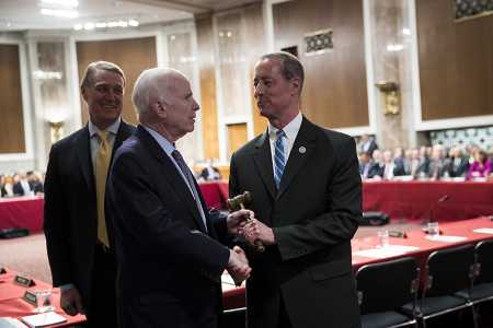 Sen. John McCain (R-Ariz.) hands over the gavel to Rep. Mac Thornberry (R-Texas) at the start of an Armed Services conference committee meeting on the National Defense Authorization Act on Capitol Hill October 25. (Photo credit: Drew Angerer/Getty Images)