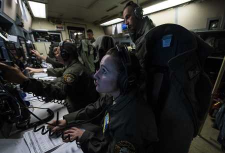 From a Navy E-6 Mercury flying above the Pacific Ocean, an Air Force officer monitors the status of an unarmed Minuteman III missile being test launched April 26, 2017 from Vandenberg Air Force Base, California, by a control system aboard the aircraft. The E-6, a version of the commercial Boeing 707 aircraft, is intended to provide a survivable communication link from the president and other elements of the National Command Authority to the U.S. nuclear forces. (Photo: Keifer Bowes/U.S. Air Force)