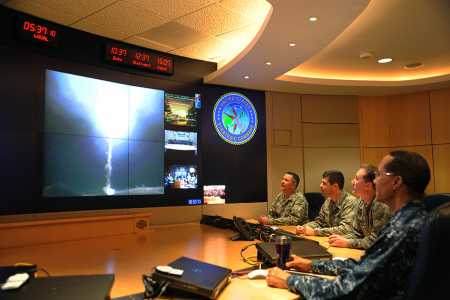 U.S. Navy Admiral Cecil Haney (right), then-U.S. Strategic Command commander, and other officers monitor from Offutt Air Force Base, Neb., a Minuteman III missile test launch at Vandenberg Air Force Base, Calif., May 20, 2015. Presidents from Dwight Eisenhower through Ronald Reagan pre-delegated nuclear release authority extensively to military commanders. Recognizing that could compromise civilian control, such delegation was rolled back at the end of the Cold War. (USSTRATCOM courtesy photo)