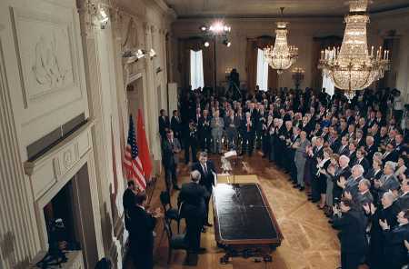 Soviet leader Mikhail Gorbachev and U.S. President Ronald Reagan shake hands December 8, 1987 at their Washington summit, as dignitaries give a standing ovation after the two leaders signed the Intermediate-Range Nuclear Forces Treaty. The ceremony was held in the East Room of the White House. (Photo: DON EMMERT/AFP/Getty Images)