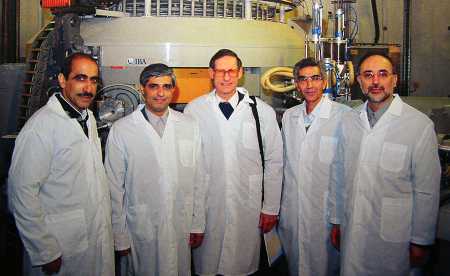 Pierre Goldschmidt (center), deputy director-general and head of the safeguards department of the International Atomic Energy Agency, visits Iran's Karaj Nuclear Research Centre for Medicine and Agriculture in February 2003. Ambassador Ali Akbar Salehi, who later became the head of the Atomic Energy Organization of Iran, stands on the far right. In the back is a medical-isotope cyclotron from the Belgian firm IBA.(Photo: Pierre Goldschmidt)