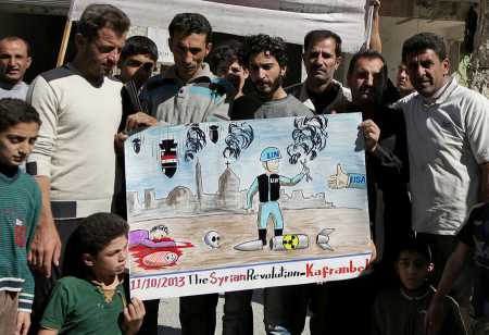 Syrian anti-government protestors hold a poster depicting an inspector from the Organisation for the Prohibition of Chemical Weapons during a demonstration October 11, 2013 calling for international action against the Damascus regime.  (Photo: MEZAR MATAR/AFP/Getty Images)