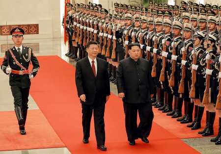 Chinese President Xi Jinping escorts North Korean leader Kim Jong Un at a welcoming ceremony March 26 in Beijing. China's Xinhua news agency said that Kim confirmed his willingness to meet with U.S. President Donald Trump, although the report did not confirm the anticipated May timeframe. Kim said 