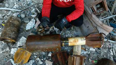 A Syrian man shows remnants of rockets reportedly fired by regime forces on the rebel-held town of Douma in the eastern Ghouta region on the outskirts of the capital Damascus on January 22, 2018. (Photo: HASAN MOHAMED/AFP/Getty Images)