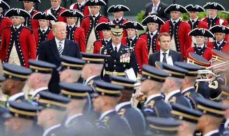 French President Emmanuel Macron (R) and U.S. President Donald Trump watch a military review at the White House on April 24. During his three-day state visit, Macron pressed Trump to maintain the Iran nuclear deal. (Photo: LUDOVIC MARIN/AFP/Getty Images)