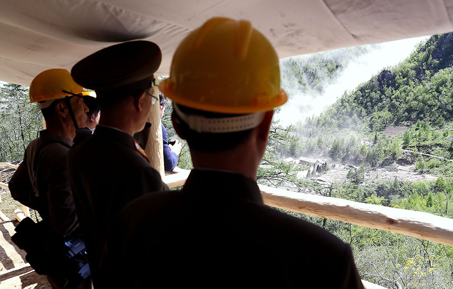 North Korean officials watch the demolition May 24 at the Punggye-ri nuclear test site, where North Korea appeared to destroy at least three tunnels, observation buildings, a metal foundry and living quarters at the remote mountain site. (Photo: News1-Dong-A Ilbo via Getty Images)