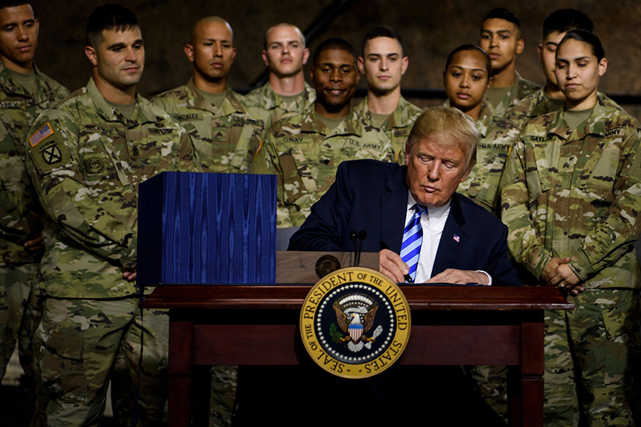 U.S. President Donald Trump signs the $716 billion John S. McCain National Defense Authorization Act for fiscal year 2019 at Fort Drum, New York, on August 13. Addressing troops at the Army base, Trump called for increasing U.S. military capabilities in space as well as creating a sixth military branch, his proposed U.S. Space Force.  (Photo: Brendan Smialowski/AFP/Getty Images)