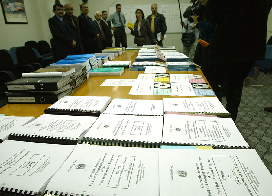 Iraqi officials present the entire 11,807-page “currently accurate, full and complete” Iraqi declaration of weapons of mass destruction programs and dual-use facilities on December 7, 2002 in Baghdad. This is an example of the kind of extensive documentation that can be used to help verify denuclearization. (Photo: Ahmed Al Rubayyh/Getty Images)