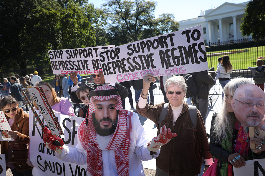 A protester dressed as Saudi Arabian Crown Prince Mohammad bin Salman demonstrates with members of the group Code Pink on October 19 outside the White House in the wake of the killing of Saudi Arabian Jamal Khashoggi. (Photo: Win McNamee/Getty Images)