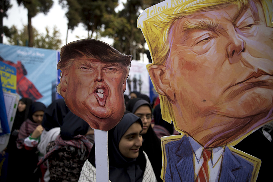 Ahead of renewed sanctions imposed by the United States, Iranians protest November 4 outside the former U.S. embassy in Tehran, marking the anniversary of the start of the 1979 hostage crisis. At rallies in the capital and other Iranian cities, protesters carried placards that mock President Donald Trump, wiped their feet on fake dollar bills, and engaged in the ritual of burning the U.S. flag.  (Photo: Majid Saeedi/Getty Images)