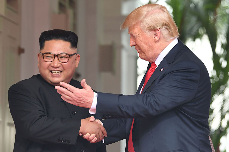 U.S. President Donald Trump shakes hands with North Korean leader Kim Jong Un at the start of their historic summit at the Capella Hotel on Sentosa Island in Singapore on June 12. The challenge will be to implement their summit declaration, including the “complete denuclearization” of the Korean peninsula. (Photo: Saul Loeb/AFP/Getty Images)