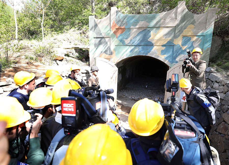 At North Korea's Punggye-ri nuclear test site, international journalists stand near a tunnel entrance before its demolition May 24. No international experts were invited to verify the extent of the destruction of the tunnel network at the remote, mountainous site. (Photo: News1-Dong-A Ilbo via Getty Images)