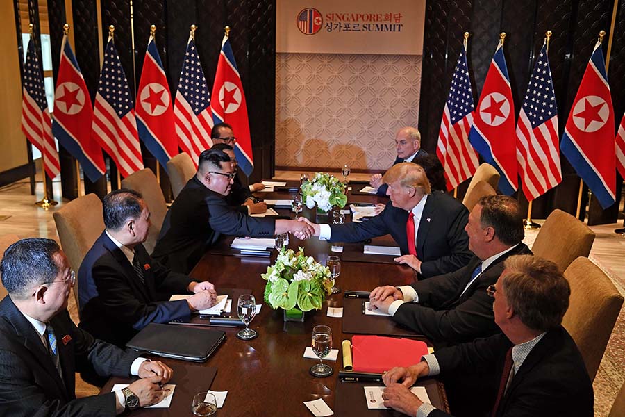 U.S. President Donald Trump shakes hands with North Korean leader Kim Jong Un as they sit down with their respective delegations for the U.S.-North Korea summit, at the Capella Hotel on Sentosa Island in Singapore, June 12.  (Photo:  Saul Loeb/AFP/Getty Images)