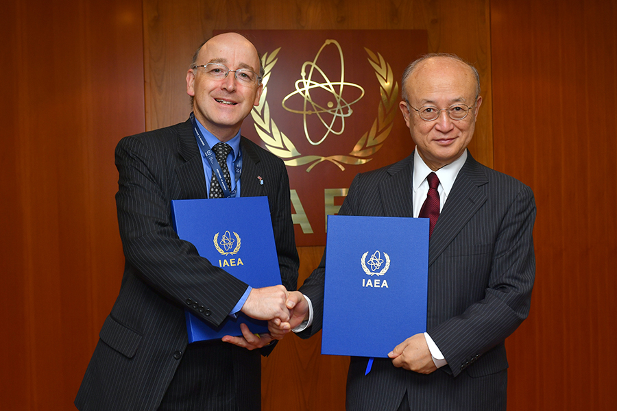 International Atomic Energy Agency Director-General Yukiya Amano and David Hall, resident representative of the United Kingdom to the IAEA, shake hands following the signing of UK’s additional protocol at IAEA headquarters in Vienna June 7.  (Photo: Dean Calma/IAEA)