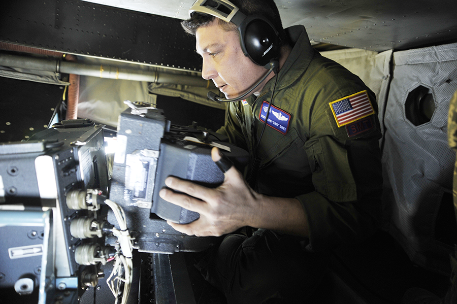 U.S. Air Force Master Sgt. David Dines changes out the film aboard an OC-135B Open Skies observation aircraft during pre-flight checks January 16, 2010, at Joint Base Andrews, Md. (Photo: Perry Aston/U.S. Air Force)