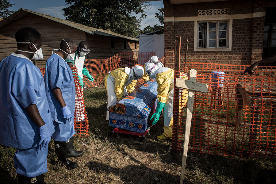 Medical workers disinfect the coffin of a suspected Ebola victim on August 13, 2018, in the Democratic Republic of the Congo. In December, delegates to the Biological Weapons Convention conference in Geneva considered how to improve international measures against diseases such as Ebola, misuse of scientific advances such as gene editing, and possible covert bioweapons programs. (Photo: John Wessels/AFP/Getty Images)