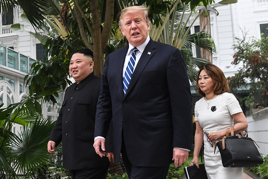 North Korean leader Kim Jong Un (left) and U.S. President Donald Trump stroll in a Hanoi hotel garden during a break from their second summit on February 28.  (Photo: Saul Loeb/AFP/Getty Images)