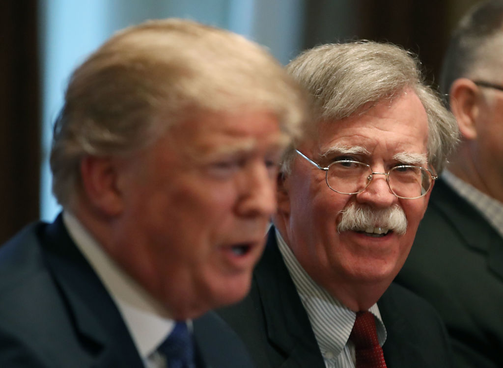 National Security Advisor John Bolton (R), listens to President Donald Trump during a briefing from senior military leaders, in the Cabinet Room on April 9, 2018. (Photo by Mark Wilson/Getty Images)