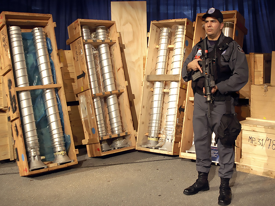 A guard keeps watch over Libyan uranium-enrichment centrifuges transferred to the United States in 2004. The end of Libya's nuclear weapons program was verified by the International Atomic Energy Agency. (Photo: U.S. Energy Department)