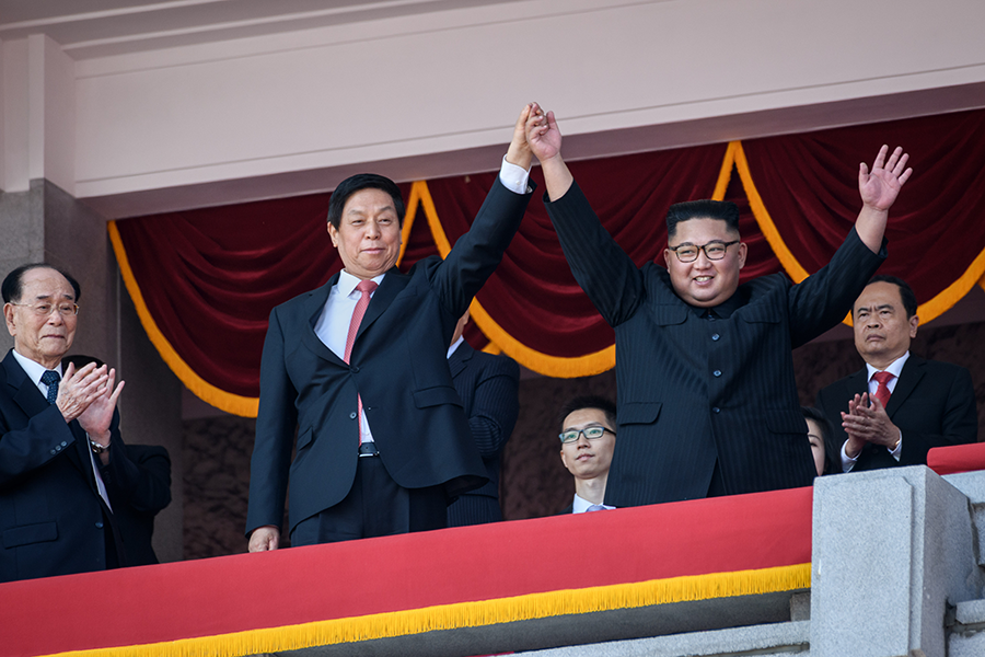North Korean leader Kim Jong Un (right) waves with China's Chairman of the Standing Committee of the National People's Congress Li Zhanshu following a September 2018 military parade which featured a missile that North Korea apparently tested May 4. (Photo: Ed Jones/AFP/Getty Images)