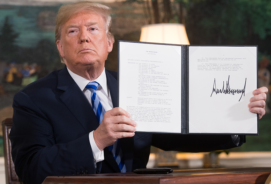 President Donald Trump signs a document reinstating sanctions against Iran after announcing the U.S. withdrawal from the Iran Nuclear deal, in the Diplomatic Reception Room at the White House in Washington, DC, on May 8, 2018. (Photo credit: Saul Loeb/AFP/Getty Images)