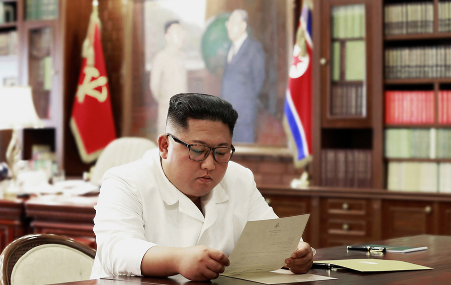 North Korean leader Kim Jong Un examines a letter from President Donald Trump in June. (Photo: Korean Central News Agency)