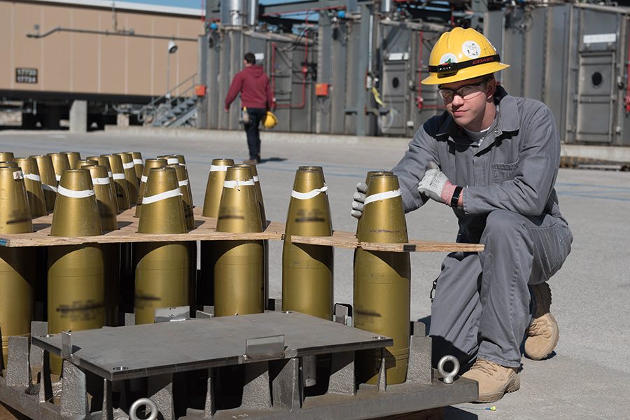A worker at the Blue Grass Chemical-Agent Destruction Pilot Plant poses with non-contaminated projectiles in November 2018. The facility has begun to destroy more than 100,000 chemical munitions stored at the site. (Photo: U.S. Army)