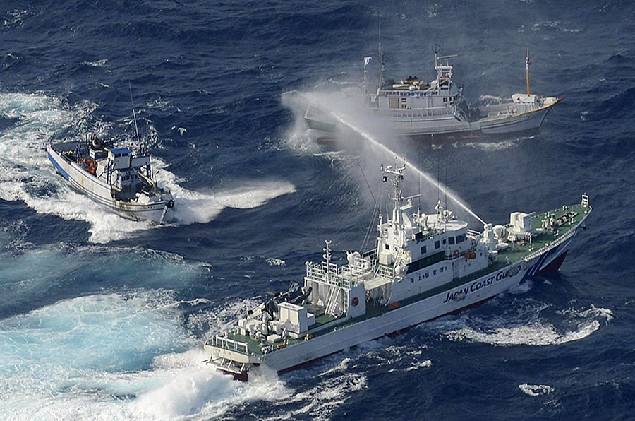 A Japan Coast Guard vessel sprays Taiwanese fishing boats with water near the Senkaku islands in September 2012. The dispute over the islands' sovereignty  could create risks that a small conflict could escalate quickly. (Photo: Yomiuri Shimbun/AFP/GettyImages)