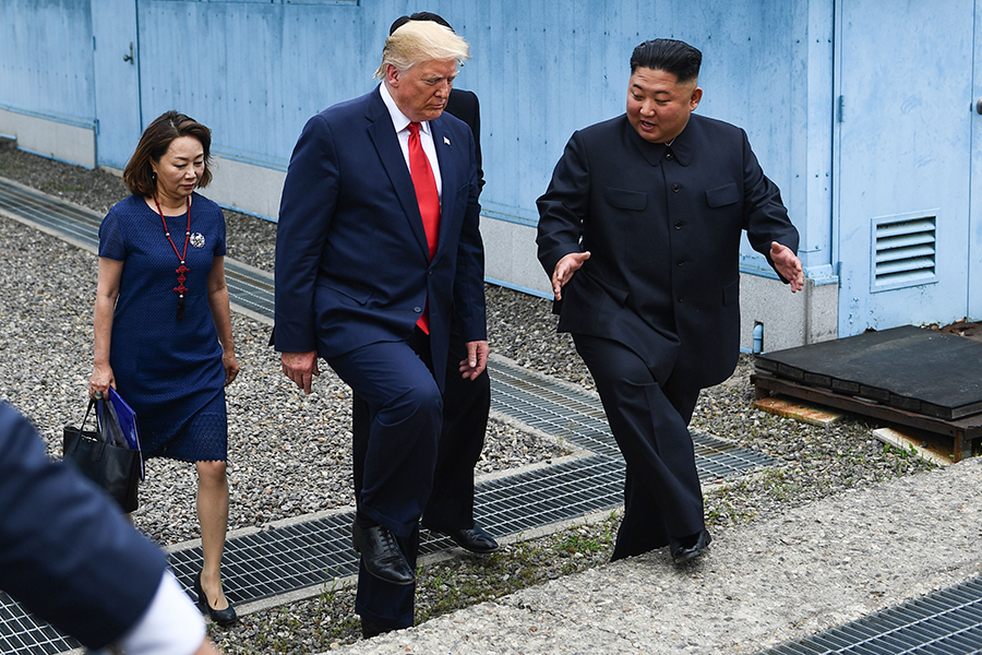 U.S. President Donald Trump and North Korean leader Kim Jong Un walk together at the border of North and South Korea in June 2019. Kim has said North Korea will no longer be bound by his moratorium on nuclear and long-range missile testing. (Photo: Brendan Smialowski/AFP/Getty Images)