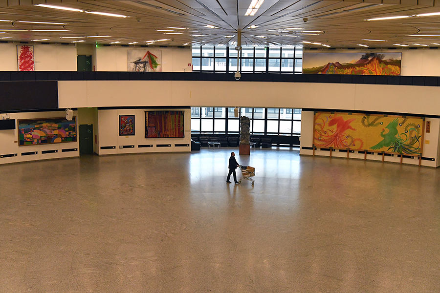 A lone worker walks through the rotunda of the Vienna International Centre on March 19. The center normally houses more than 2,200 IAEA employees who have been directed to work at home during the public health crisis caused by the novel coronavirus. (Photo: Dean Calma/IAEA)