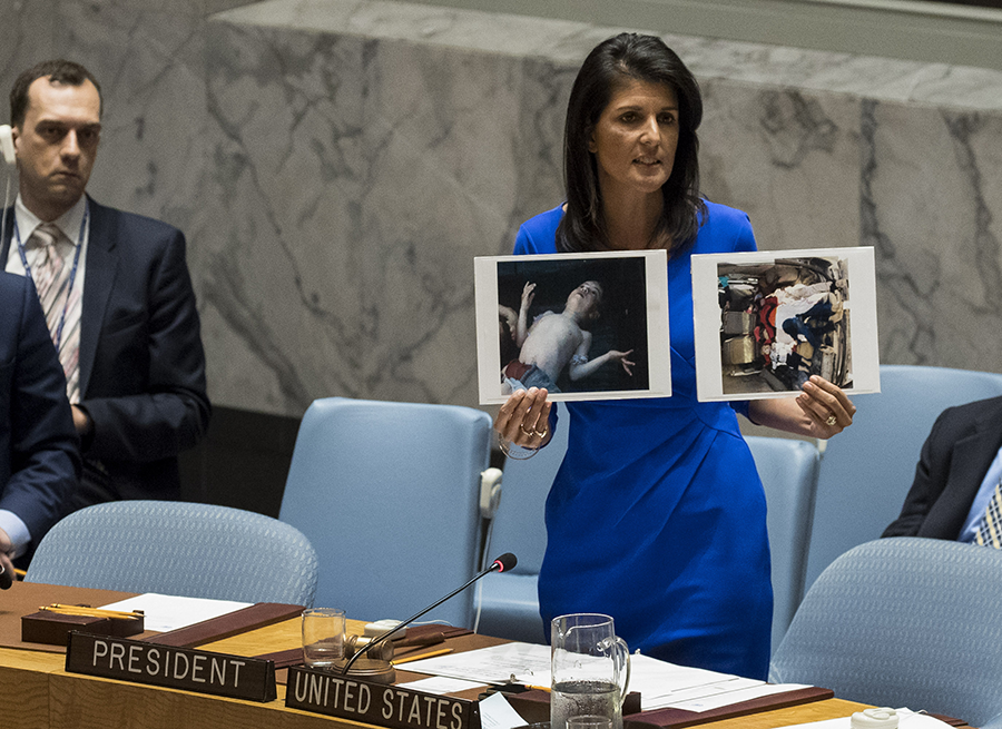 U.S. Ambassador to the United Nations Nikki Haley holds up photos of victims of the Syrian chemical attack during a meeting of the UN Security Council on, April 5, 2017. (Photo: Drew Angerer/Getty Images)