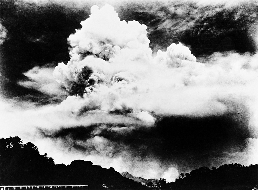 Three days later, the city of Nagasaki burns following the decision by U.S. leaders to drop “Fat Man,” a plutonium-based bomb with an explosive yield estimated at 21 kilotons, on the city of approximately 260,000 at the time of the attack. (Photo: UN/Nagasaki International Cultural Hall)